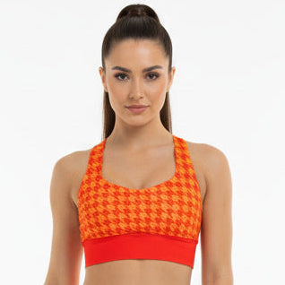 Woman wearing an orange checkered outfit on a white background